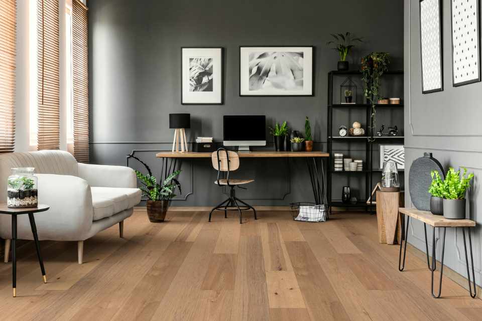 hickory hardwood flooring in modern gray living room with home office set up